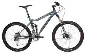 Salsa El Kaboing: Mountain bike with a gray frame, front suspension, and disc brakes, featuring wide tires designed for off-road terrain.