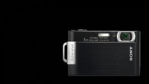 Sony Cybershot DSC T200: A black Sony compact camera with a silver accent, featuring a lens and a zoom indicator, set against a plain black background.