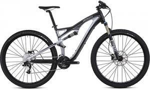 Specialized Camber 29: A mountain bike with a sleek black and silver frame, featuring a suspension system, wide tires, and a modern design.