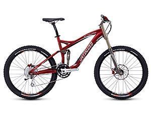 Specialized Enduro SL Pro: A red mountain bike with wide tires and a sturdy frame, designed for off-road riding, featuring front suspension and disc brakes.
