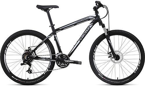 Specialized Hardrock Disc: A sleek black mountain bike with a lightweight frame, front suspension, and wide tires, showcasing a modern design suitable for outdoor trails and rugged terrain.