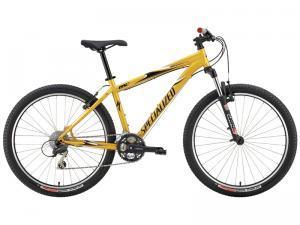 Specialized Rockhopper: A bright yellow mountain bike with a sturdy frame, featuring wide tires and adjustable handlebars, positioned on a white background.