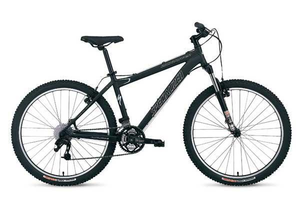 Specialized Rockhopper: A black mountain bike with wide tires, featuring a sleek frame and multiple gears. The bike is positioned at an angle, showcasing its handlebars, seat, and drivetrain components.