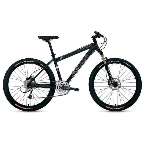 Specialized Rockhopper: A black mountain bike with a lightweight aluminum frame, featuring wide tires, disc brakes, and a front suspension fork. The bike is positioned upright, showcasing its sporty design and specialized branding.