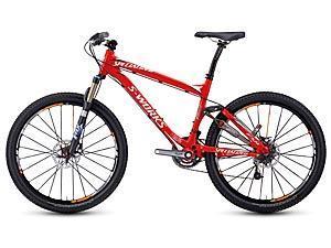 Specialized S-Works Epic Carbon Disc: Image of a red Specialized S-Works mountain bike with front suspension, disc brakes, and thick tires, designed for off-road cycling.