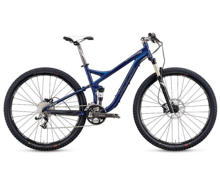 Specialized Stumpjumper FSR 29: A blue modern mountain bike with a lightweight frame, equipped with durable tires, a front suspension fork, and multiple gears, positioned on a white background.