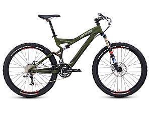 Specialized Stumpjumper FSR: A mountain bike with an olive green frame, featuring wide tires and disc brakes. The bike has a sleek design, a suspension fork, and a comfortable seat, ideal for off-road trails.