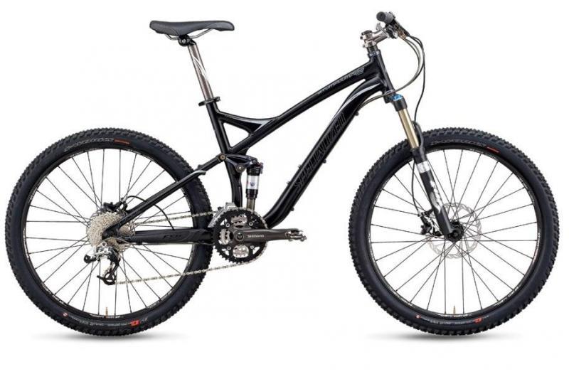 Specialized Stumpjumper FSR: A black mountain bike with a sleek frame, featuring wide tires, a suspension fork, and multiple gears.
