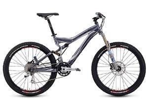 Specialized Stumpjumper FSR Expert: A mountain bike with a sleek silver and black frame, featuring wide tires, disc brakes, and a modern suspension system, designed for off-road cycling.