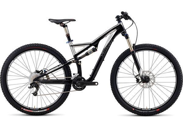 Specialized Stumpjumper FSR Expert: A black and silver mountain bike featuring a full suspension design, wide tires, and a modern frame. The bike is positioned on a white background, showcasing its gears and disc brakes.