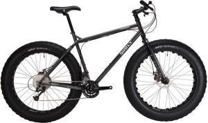 Surly Moonlander: A black fat tire mountain bike with oversized tires, a sturdy frame, and a traditional handlebar setup, positioned against a white background.