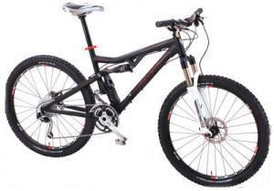 Tomac Automatic: A black mountain bike with red accents, featuring knobby tires, a front suspension fork, and a sleek frame design.