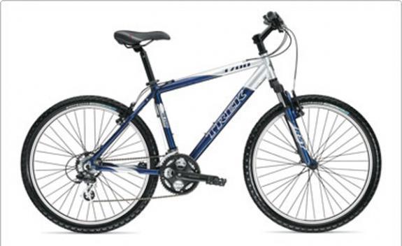 Trek 3700: A blue and white mountain bike with wide tires, front suspension, and a sporty design, displayed against a plain background.
