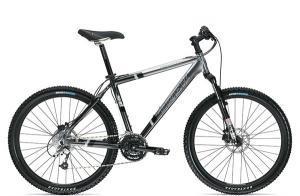 Trek 4900: A black and silver mountain bike with a sturdy frame, thick tires, and a comfortable seat, positioned against a plain white background.
