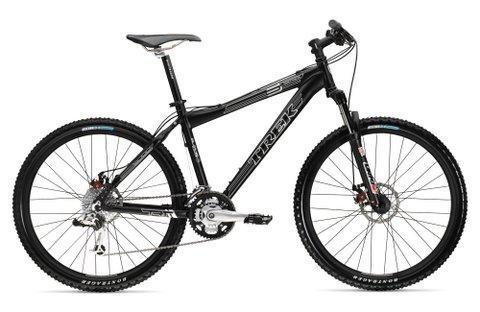 Trek 6000: A black mountain bike from the brand Trek, featuring a sturdy frame, thick tires with tread for traction, and a suspension system. The bike has a sleek design suitable for off-road cycling.