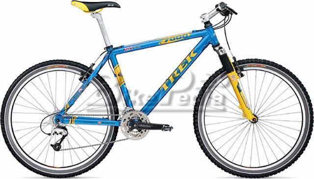 Trek 7000: Image of a blue and yellow Trek mountain bike with a lightweight frame, front suspension, and knobby tires. The bike features a Shimano derailleur and a classic design, ideal for off-road riding.