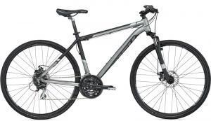 Trek 8.3 DS: A modern hybrid bicycle featuring a sleek silver and black design, with front suspension, disc brakes, and thin tires suitable for both road and off-road riding.