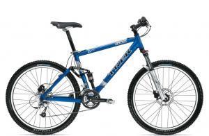 Trek Fuel 70: A blue mountain bike with a sturdy frame, front suspension, and knobby tires, positioned against a plain background.