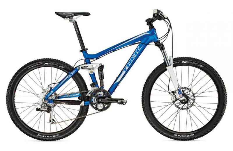 Trek Fuel EX 5: A blue mountain bike with a sleek frame and multiple gear components, featuring front suspension forks, wide tires, and a Bontrager wheelset. The bike is positioned at an angle to showcase its contours and design.