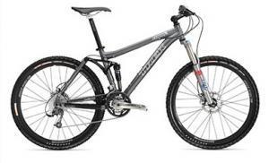 Trek Fuel EX 8: A gray and black mountain bike with thick tires, a suspension fork, and a sleek frame design.
