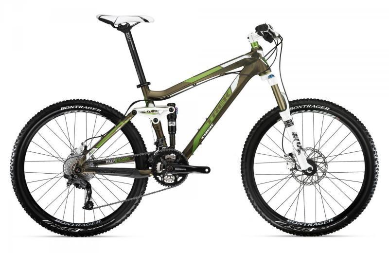 Trek Fuel EX 8: A green and brown mountain bike with a full suspension system, featuring wide tires and disc brakes. The bike has a sleek design with a characteristic frame and a white seat, positioned upright against a plain white background.