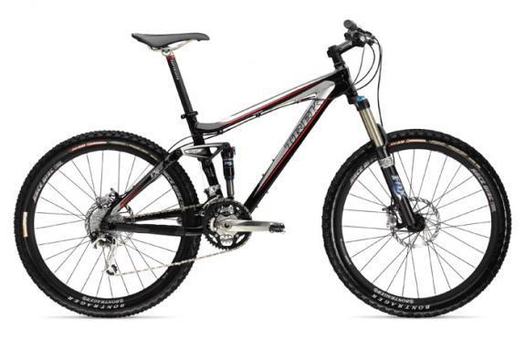 Trek Fuel EX 8: A black and red mountain bike with front suspension, wide tires, and disc brakes, viewed from the side against a white background.