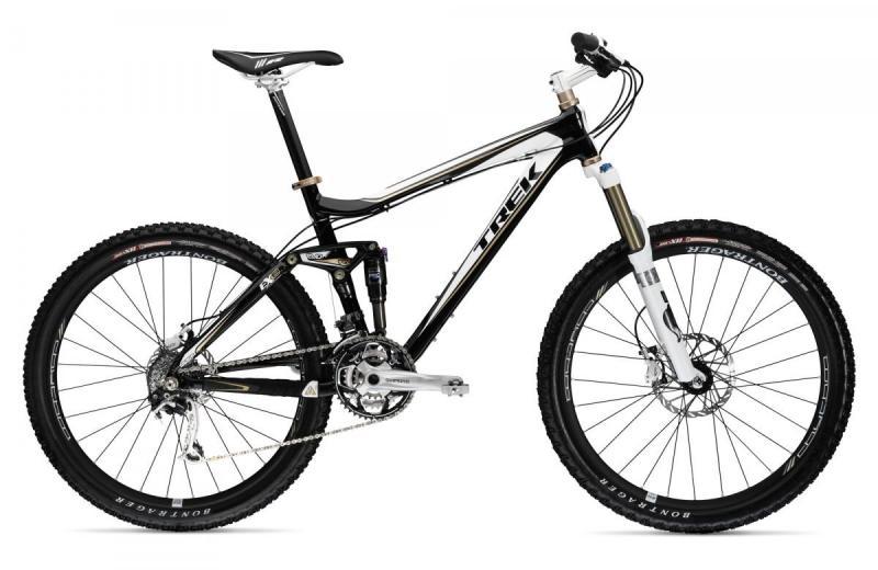 Trek Fuel EX 8: A black and white Trek mountain bike with a dual suspension system, featuring wide tires and disc brakes, positioned on a plain background.