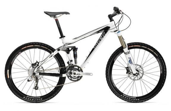 Trek Fuel EX 9: Mountain bike with a white frame, front suspension fork, and wide tires, displaying a modern design suitable for off-road cycling.
