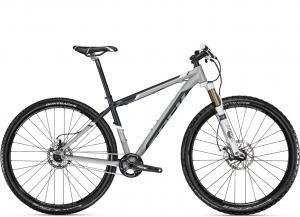 A modern mountain bike with a sleek gray and black design, featuring front suspension, wide tires, and disc brakes. The bike is displayed upright against a white background, highlighting its frame and components.