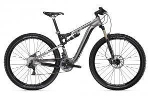 Trek Rumblefish: A modern mountain bike with a sleek silver and black design, featuring suspension forks, disc brakes, and thick tires suitable for rugged terrain.