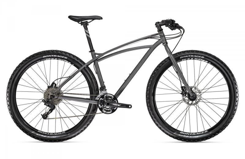 Trek Sawyer: A gray mountain bike with a lightweight frame, featuring front suspension, disc brakes, and rugged tires suitable for off-road terrain. The bike is shown from a side angle, highlighting its sleek design and various components.