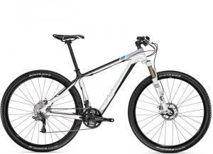 Trek Superfly: A modern mountain bike featuring a sleek frame design, front suspension fork, disc brakes, and wide tires, positioned against a neutral background.