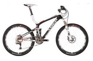 Trek Top Fuel: A sleek black and white mountain bike with disc brakes, a lightweight frame, and knobby tires, positioned against a plain background.