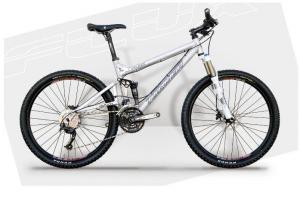 Turner Flux: A silver mountain bike with front suspension, thick tires, and a sleek frame, displayed against a light gray background.