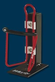 Velocity Velocage: Red and black bicycle bottle holder mounted on a sturdy black base, designed to securely hold a drink bottle while cycling.