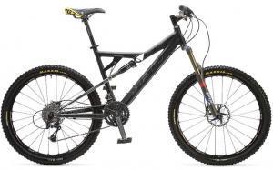 Yeti 575: A black mountain bike with yellow accents, featuring wide tires, a full suspension frame, and disc brakes, positioned on a white background.