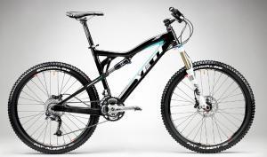 Yeti ASR 5 Alloy: A black and blue Yeti mountain bike with a suspension frame, featuring wide tires and disc brakes, displayed against a gradient gray background.
