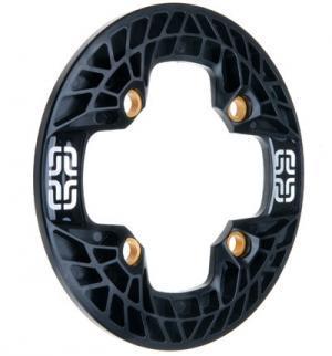 e*thirteen Turbocharger: Black bicycle chainring with a circular design, featuring a cut-out center and a patterned surface. It includes four golden mounting holes and has a decorative white logo on one side.
