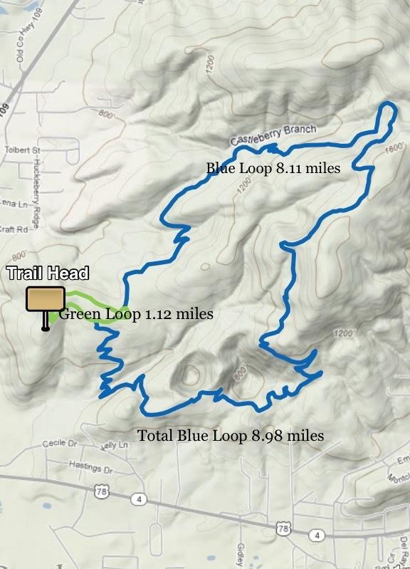 Map showing two hiking trails: the Blue Loop, measuring 8.11 miles, and the Green Loop, measuring 1.12 miles. The starting point is labeled as "Trail Head," and the total distance for the Blue Loop area is 8.98 miles. Contours indicate elevation changes in the terrain. Coldwater Mountain mountain bike trail.