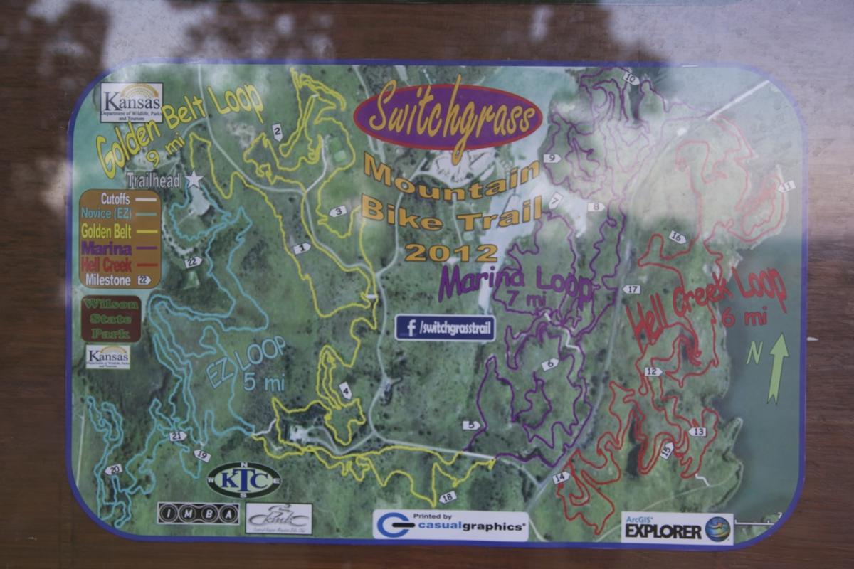 Map of the Switchgrass Mountain Bike Trail, featuring various trails such as the Golden Belt Loop (9 miles), Marina Loop (7 miles), and Hell Creek Loop (6 miles). The map includes cutoffs, trail difficulty levels, and markers for Wilson State Park. It is labeled with a north indicator and features colorful lines representing different biking paths. Switchgrass mountain bike trail.