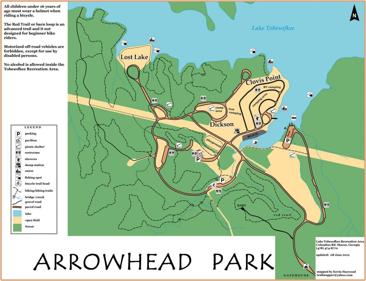 Map of Arrowhead Park in Macon, Georgia, showing trails, camping areas, and amenities such as restrooms, picnic shelters, and a beach. Key features include Lost Lake, Clovis Point, and Dickson, along with important guidelines for park usage. The legend outlines various symbols for navigation. Arrowhead Park mountain bike trail.