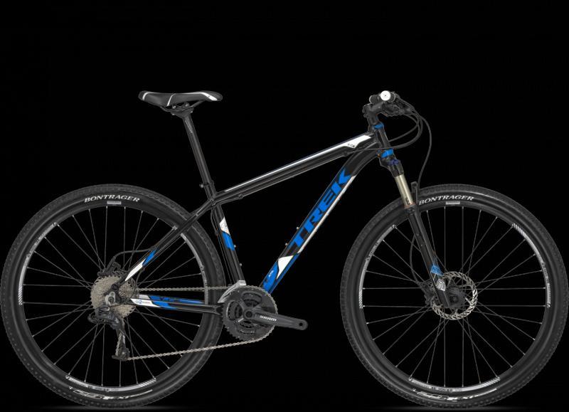Trek X-Caliber: Mountain bike with a black and blue frame, featuring front suspension and disc brakes, showcased against a black background.
