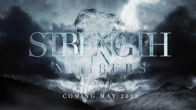 Text-based image featuring the words "STRENGTH IN NUMBERS" prominently displayed in a stylized font. The background depicts a dark, moody landscape with mountains and clouds, conveying a dramatic atmosphere. The phrase "COMING MAY 2012" is also included.