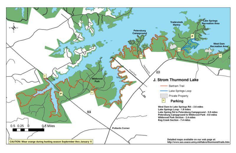 Map of J. Strom Thurmond Lake, showing trails, parking areas, and campgrounds. Key features include Wildwood Park, Petersburg Campground, and various marked trails such as the Bartram Trail and Lake Springs Loop. The map indicates distances between locations and cautions to wear orange during hunting season from September through January. Bartram Trail / West Dam / Wildwood Park mountain bike trail.