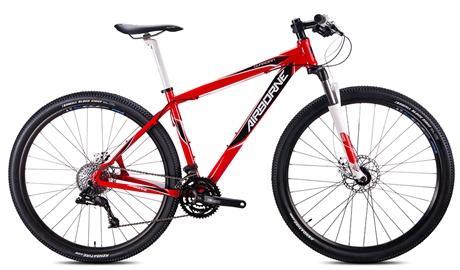 Airborne Guardian: A red and white mountain bike with a lightweight frame, featuring thick tires and a front suspension fork, positioned against a white background.