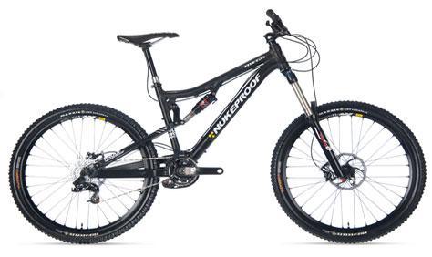 Nukeproof Mega: A black mountain bike with prominent suspension features, wide tires, and a sleek design, showcasing the brand name "Nukeproof" on the frame.