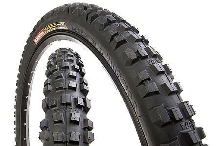 Kenda Kinetics: A close-up view of a mountain bike tire showcasing its knobby tread pattern, designed for enhanced traction on rough terrain. The tire is positioned diagonally, with one side displaying the brand and model information.