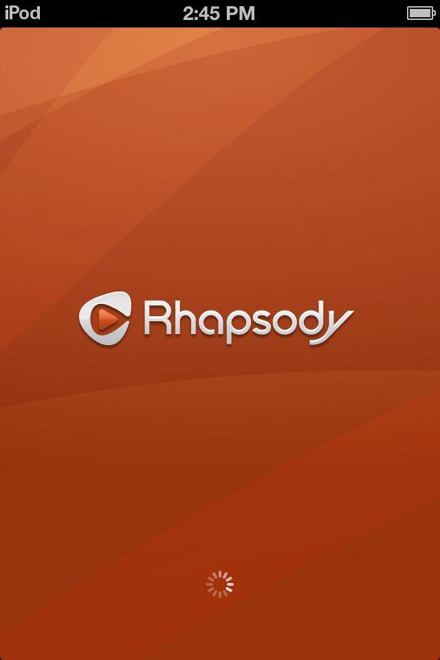 Rhapsody International Rhapsody: Loading screen for the Rhapsody music app, featuring a bold orange background with the Rhapsody logo and a loading icon at the bottom.