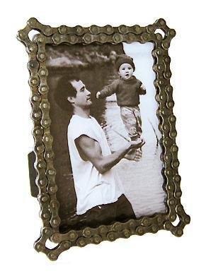 Resource Revival Recycled Bike Chain frame: A vintage-style photo frame with a decorative, ornate border, holding a black and white image of a man lifting a smiling baby in the air near a body of water.