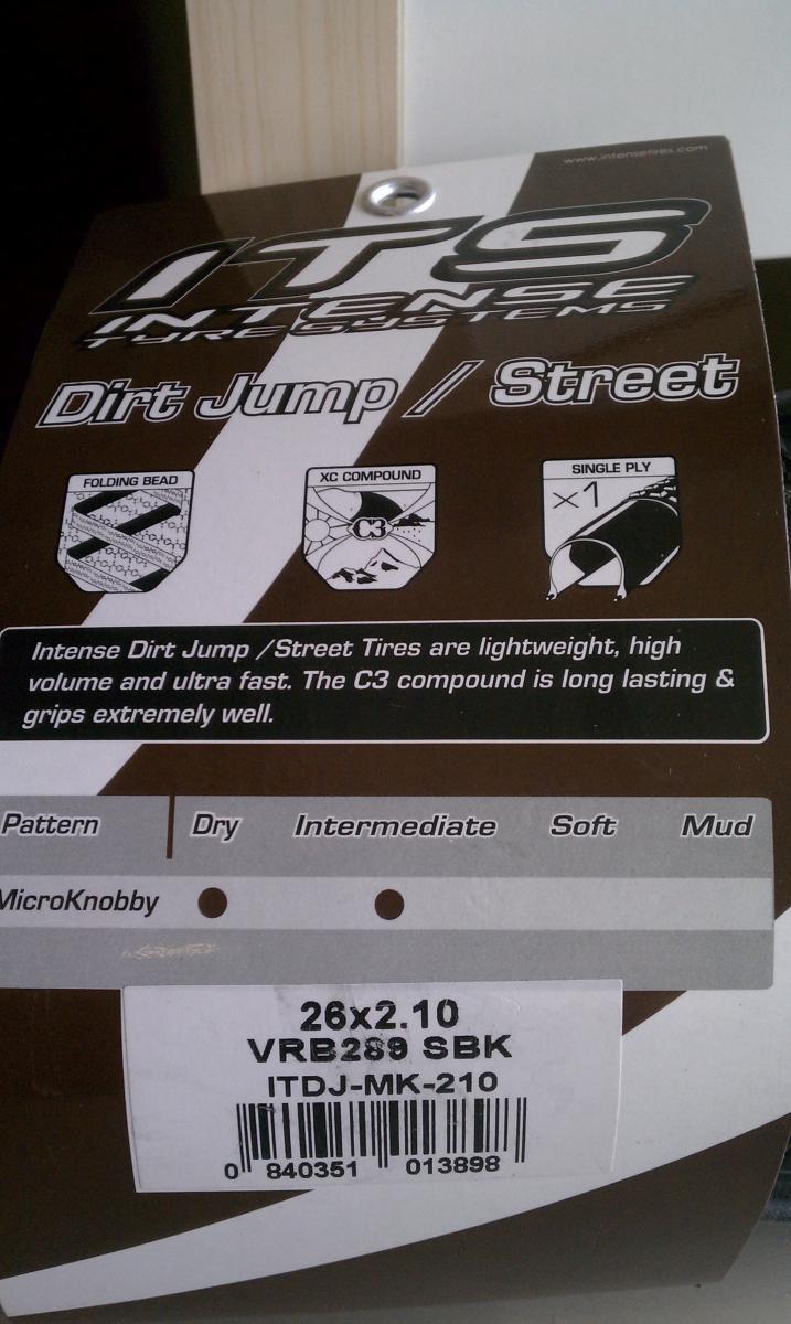 ITS Micro Knobby: Alt text: Product packaging for Intense Dirt Jump/Street Tires, featuring specifications such as size (26x2.10), compound type (C3), and attributes like lightweight design and folding bead. The packaging includes graphics summarizing tire characteristics for different terrain types.